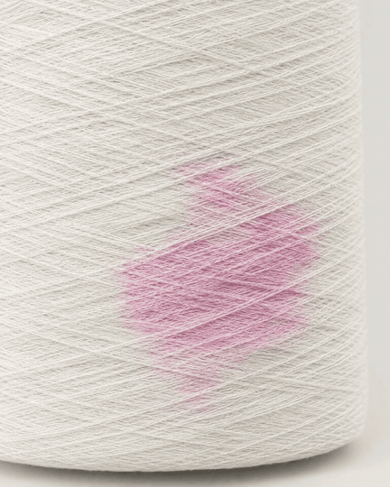 Ammonia test on a cone of the deodorising yarn: a pink patch shows ammonia, then fades to white as the yarn breaks it down